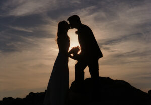 Wedding Photographer Los Angeles of bride and groom kissing by the ocean in Laguna Beach, CA