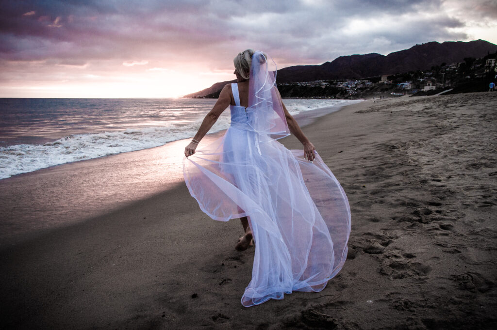Wedding Photographer Los Angeles of Bride walking on the beach in Malibu, CA